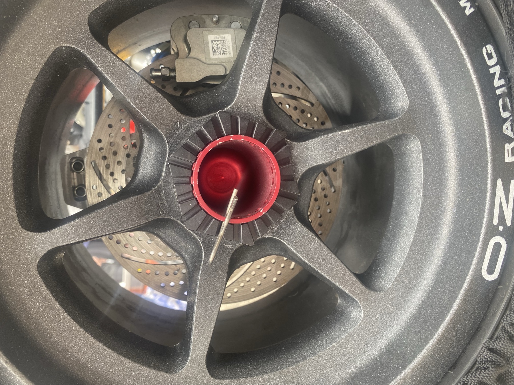 Completed brake rotor and caliper mounted behind the OZ Racing wheel